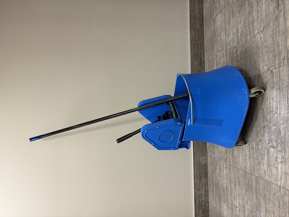 Commercial mop bucket with a down-press wringer