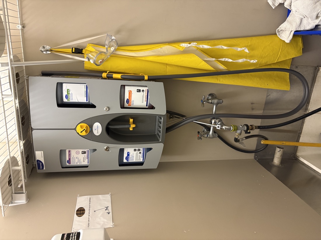 Diversey QuattroSelect chemical dispensing system at a janitorial floor sink